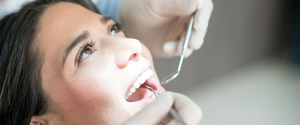 smiling woman speaking with her dentist